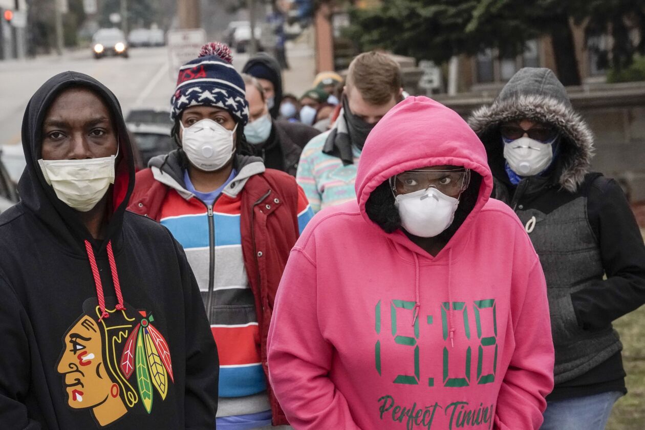 Voters masked against coronavirus line up at Riverside High School for Wisconsin’s primary election Tuesday April 7, 2020, in Milwaukee.